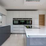 Striking Niel white shimmer quartz worktop with matching full clad on the wall. With undermounted Blanco stianless steel sink and matching Culina spray tap acompanied by a Quooker hot tap.