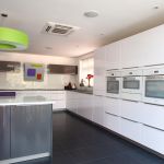 Two tone pearl grey and polar white gloss kitchen units with high end Miele integrated appliances in white.