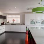 German engineered Hacker kitchen shown in pearl grey and polar white gloss with white cosmic and grey glitter quartz.