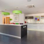 Monotone modern kitchen accessories with pops of bright colour. With LED plinth lights and under cupboard wall lights.