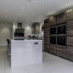 A grand island housing a 44 Bottle stainless steel Siemens wine cooler perfect for entertaining. Along with additional plug sockets on the side of the island for ease of use on all your hand held appliances when meal prepping.