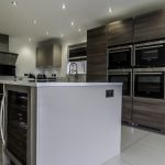 A grand island housing a 44 Bottle stainless steel Siemens wine cooler perfect for entertaining. Along with additional plug sockets on the side of the island for ease of use on all your hand held appliances when meal prepping.