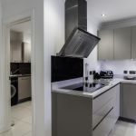 High end modern matt cashmere kitchen with matching utlity room units.
